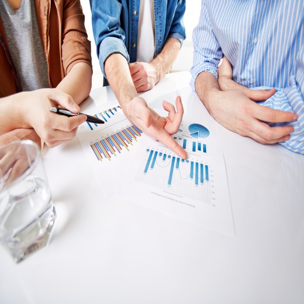 Hands of businessmen during presentation of market analysis